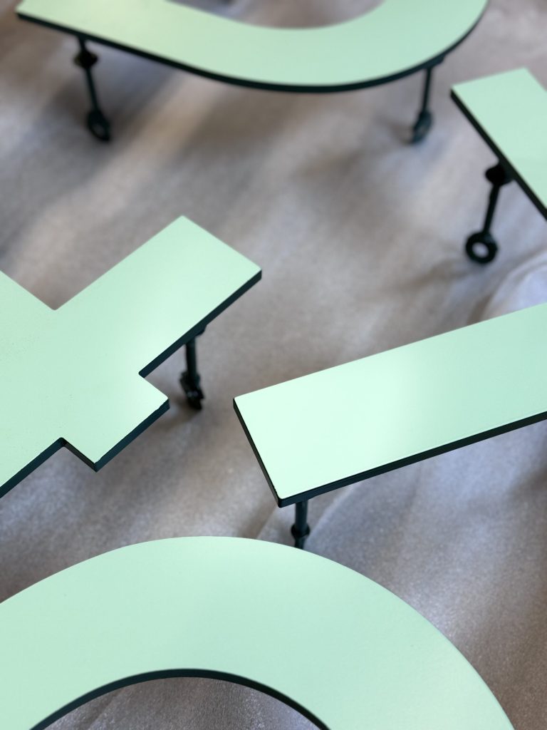 Mint green coated letters and logo elements