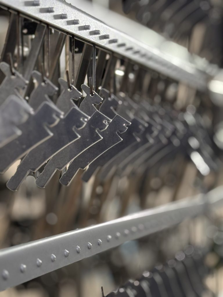 Galvanised small parts hanging on the coating line