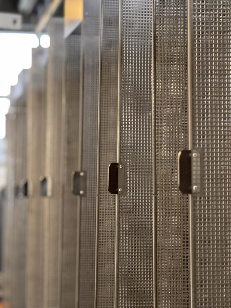 Coated perforated sheet elements for a façade