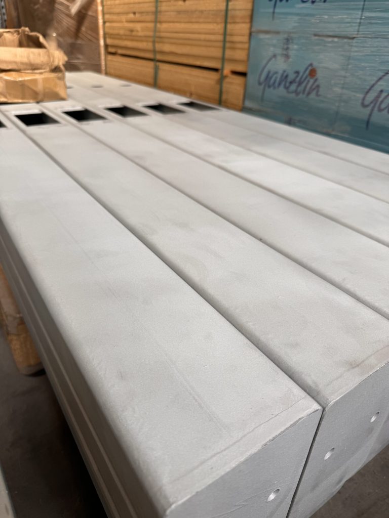 White coated long profiles on a pallet