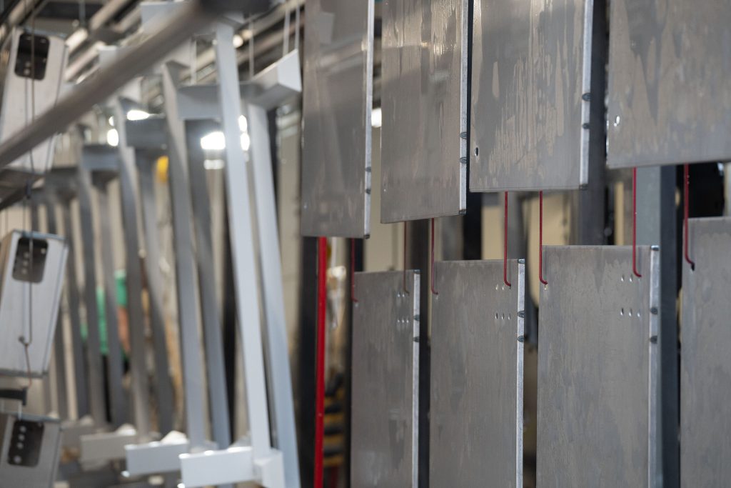 Components hanging on the powder coating line
