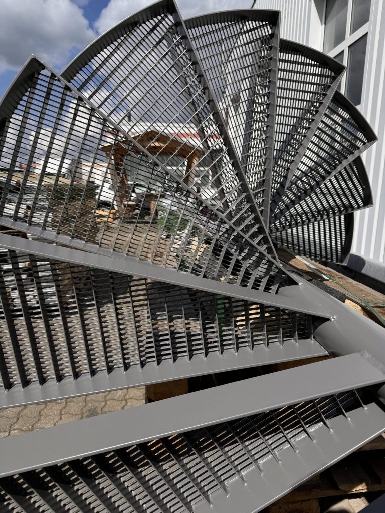Black coated spiral staircase with grating steps